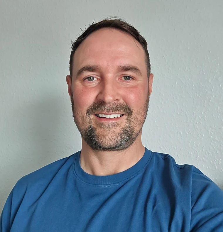 Patrick J Breheny smiling, wearing a blue shirt